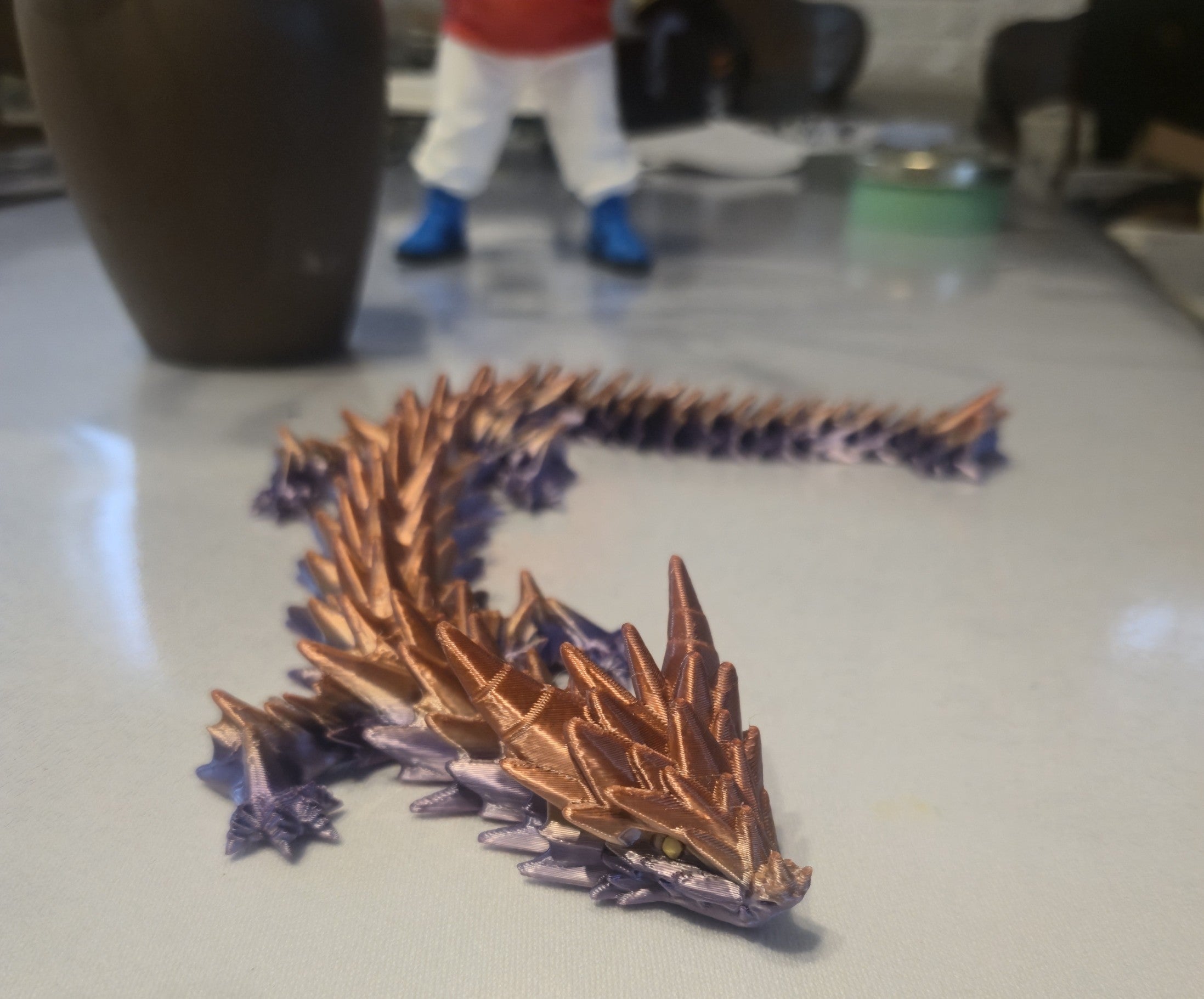 3D Print NZ articulated dragon figurine toy with copper and purple gradient, segmented body, and detailed scales.